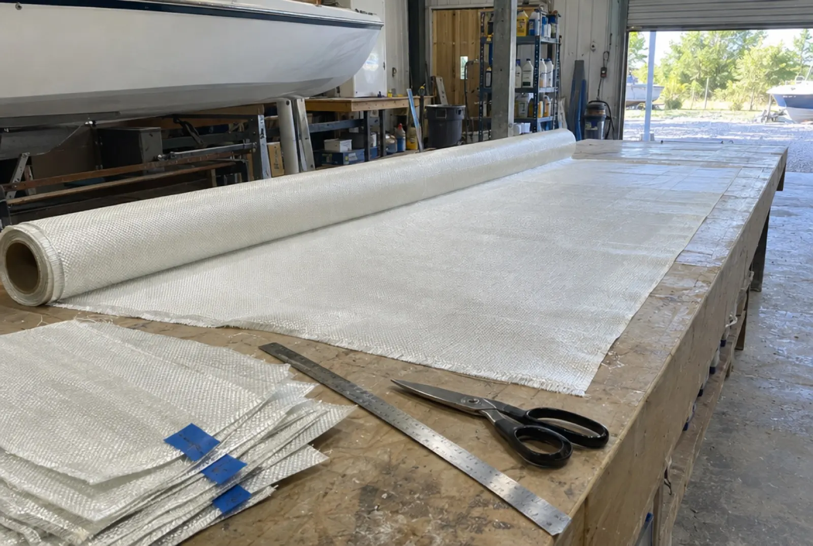 Fiberglass cloth unrolled and cut on the cutting table